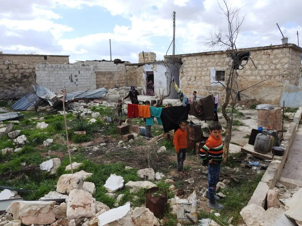 Afrin people raise resistance banners amid destruction