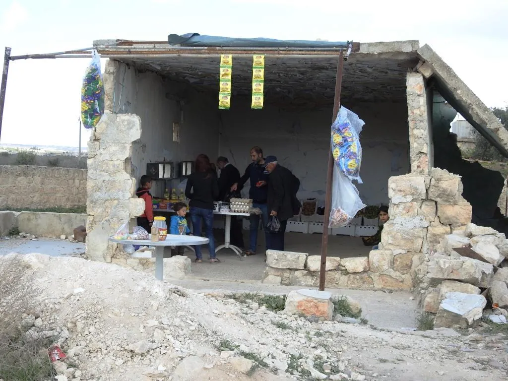 Afrin people raise resistance banners amid destruction
