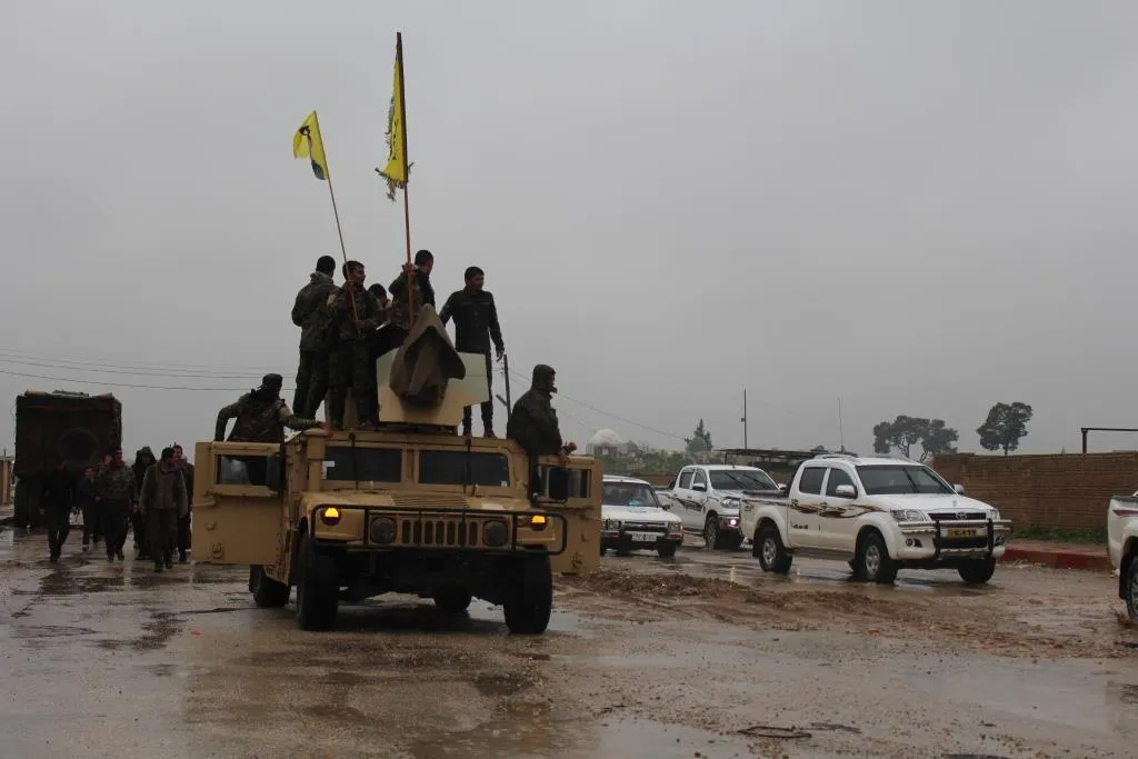 A military parade, fighters celebrate Daesh defeat