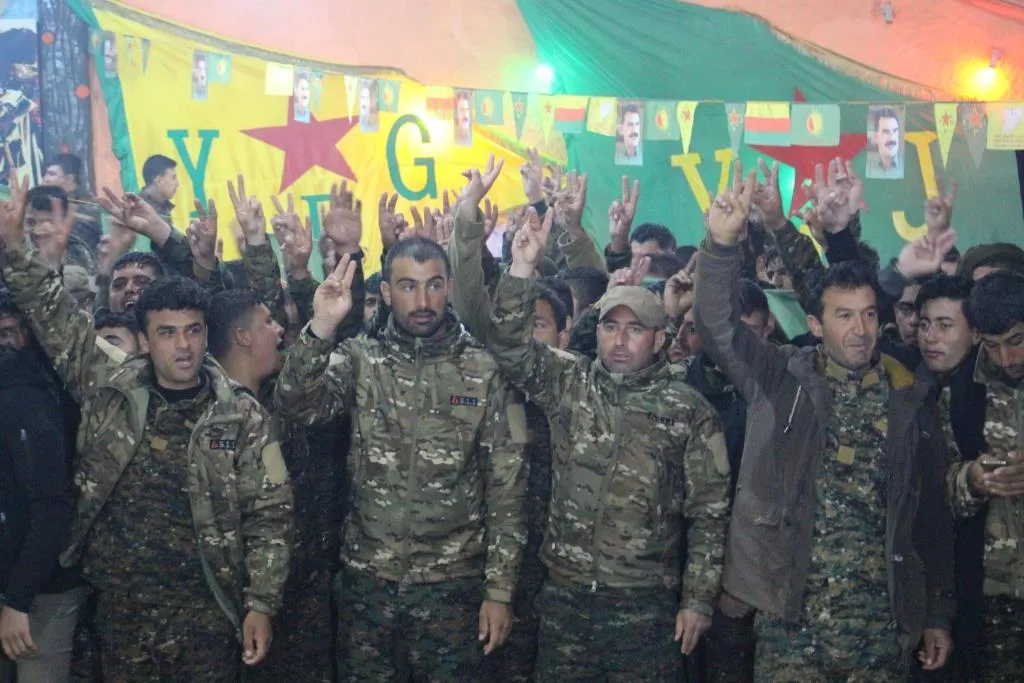 A military parade, fighters celebrate Daesh defeat