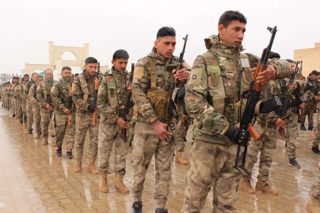 A military parade, fighters celebrate Daesh defeat