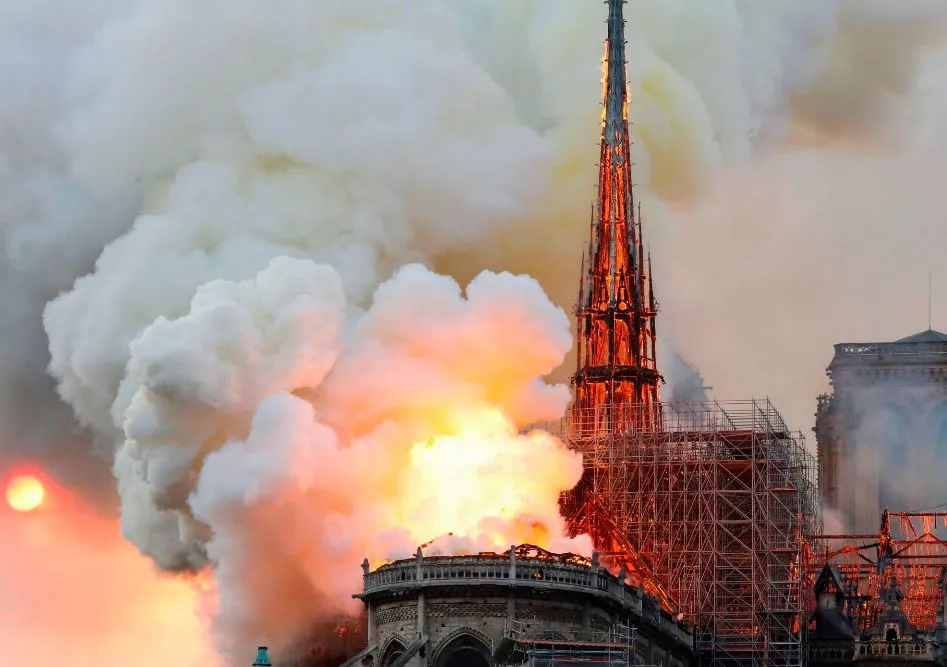 Notre-Dame Cathedral engulfed in flames, its historical tower collapse