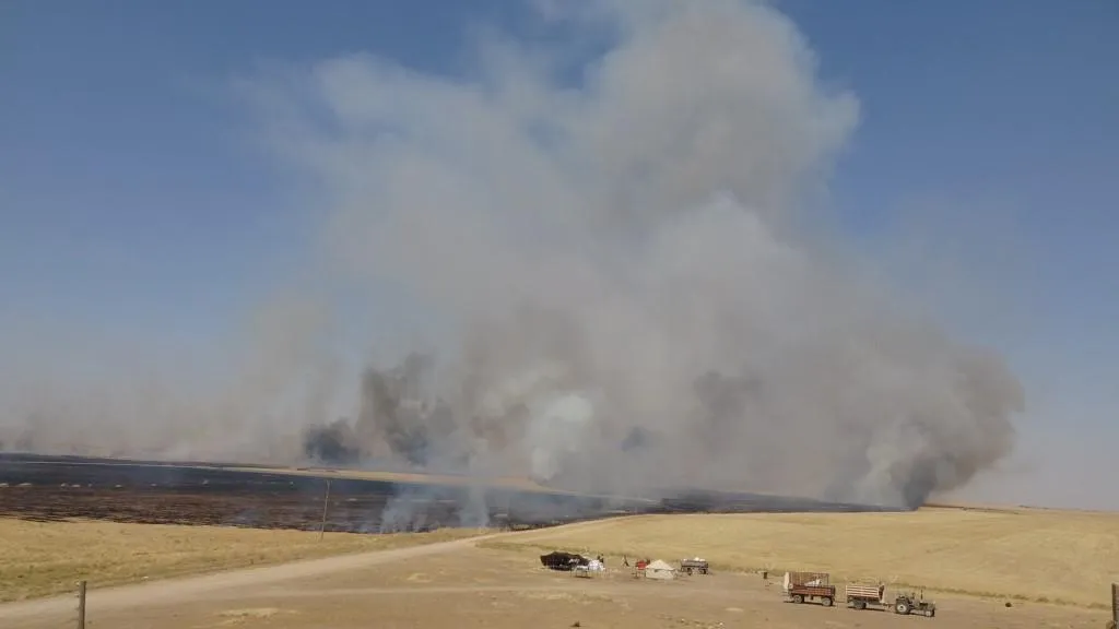 Fire extinguished after consuming 26 villages' fields in Tal Hamis, ad-Darbasiya