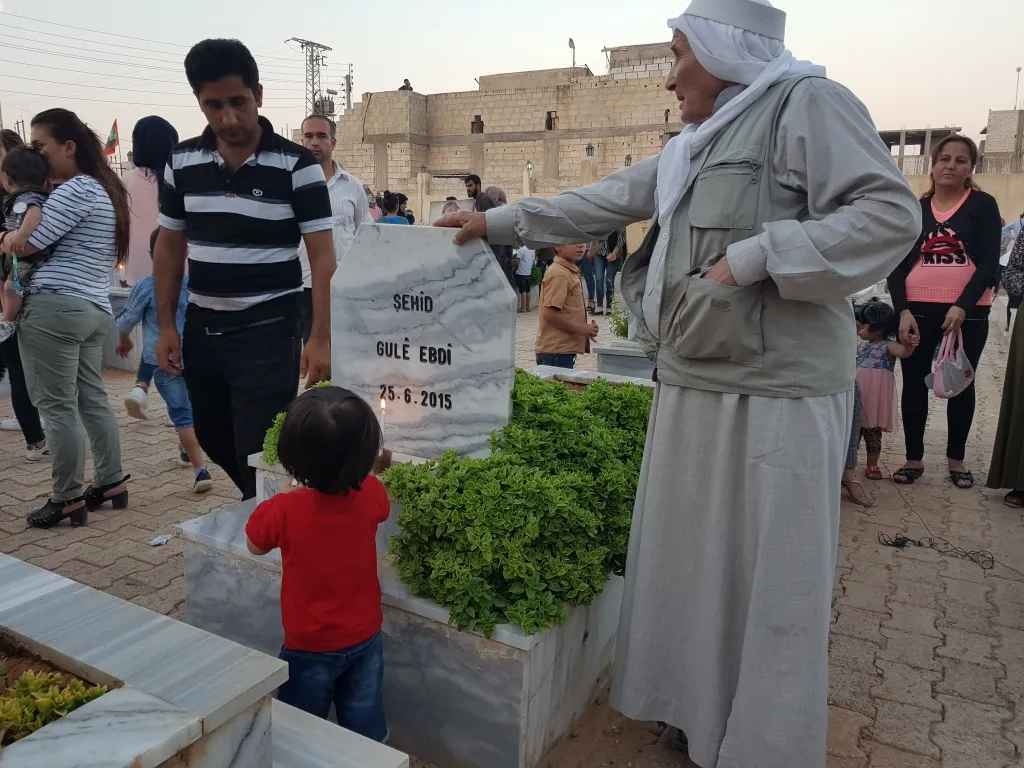Kobani people light candles on 25th June martyrs' shrines