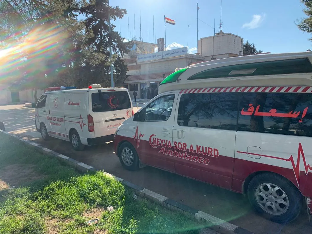 Medical teams inspect arrivals from Damascus to Qamishlo inside the airport