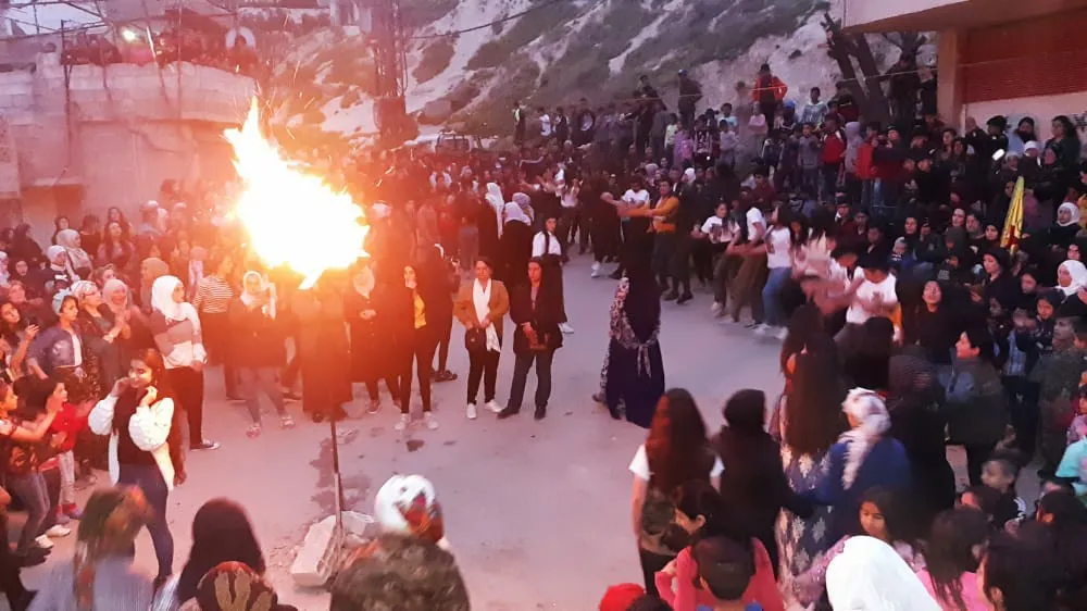 Kurds in Zor Ava neighborhood in Damascus light Newroz fire