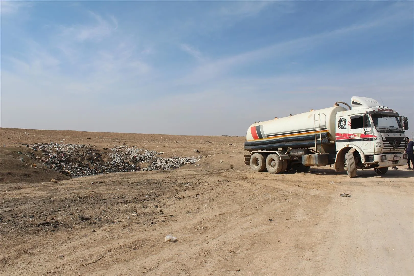 NGOs working in the Al-Hol Camp load garbage out of specified landfill