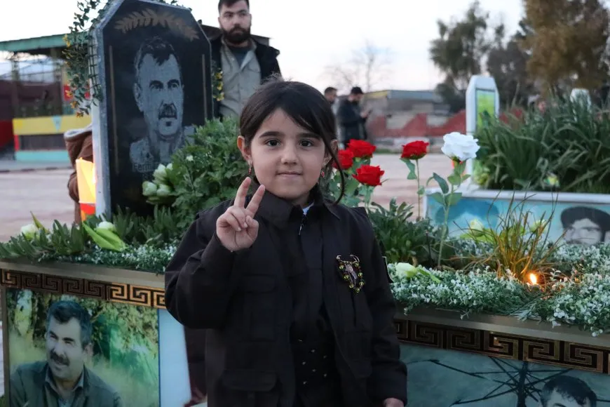 Lighting candles at Martyrs' Shrines in Qamishlo on eve of Newroz