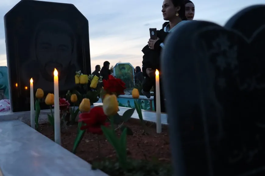 Lighting candles at Martyrs' Shrines in Qamishlo on eve of Newroz