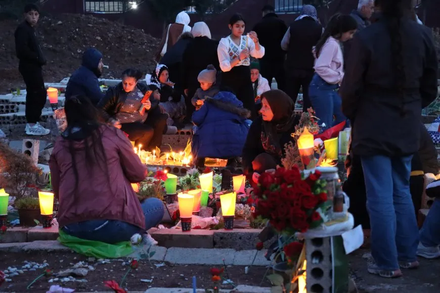 Lighting candles at Martyrs' Shrines in Qamishlo on eve of Newroz