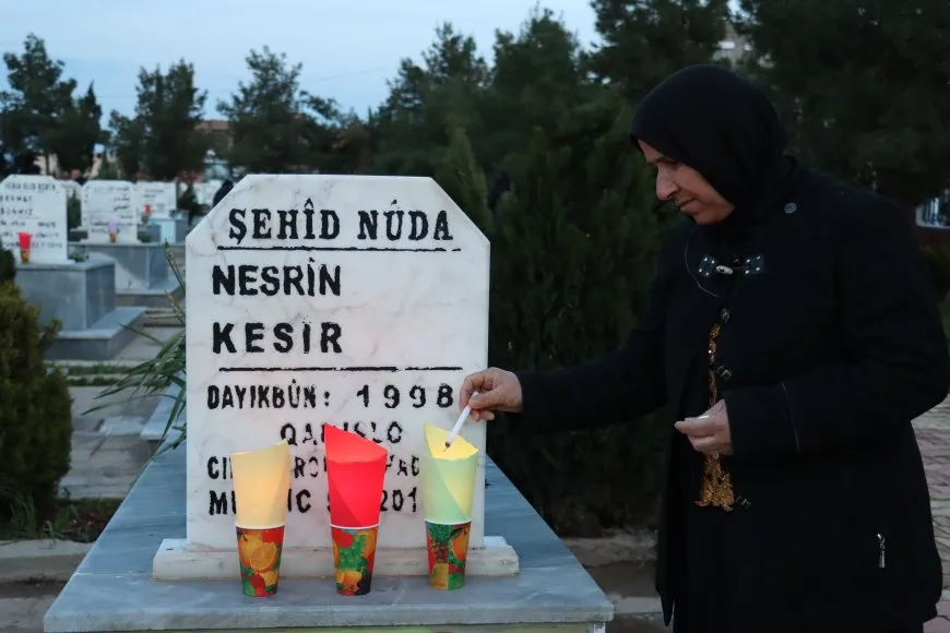 Lighting candles at Martyrs' Shrines in Qamishlo on eve of Newroz