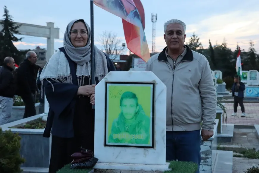 Lighting candles at Martyrs' Shrines in Qamishlo on eve of Newroz