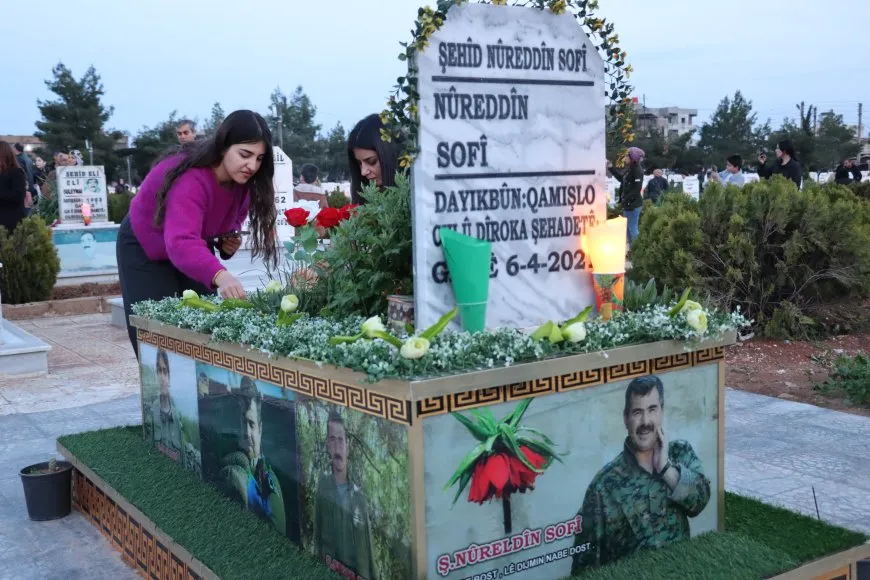 Lighting candles at Martyrs' Shrines in Qamishlo on eve of Newroz
