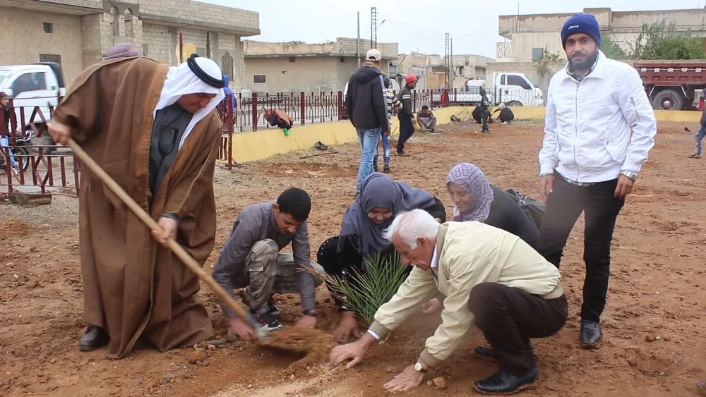 Plantando nuevo parque en al-Tabqa con clima lluvioso